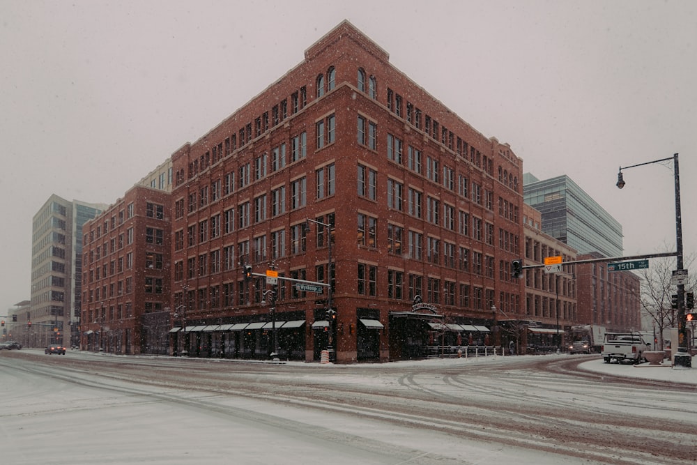 Ein großes rotes Backsteingebäude an der Ecke einer Straße