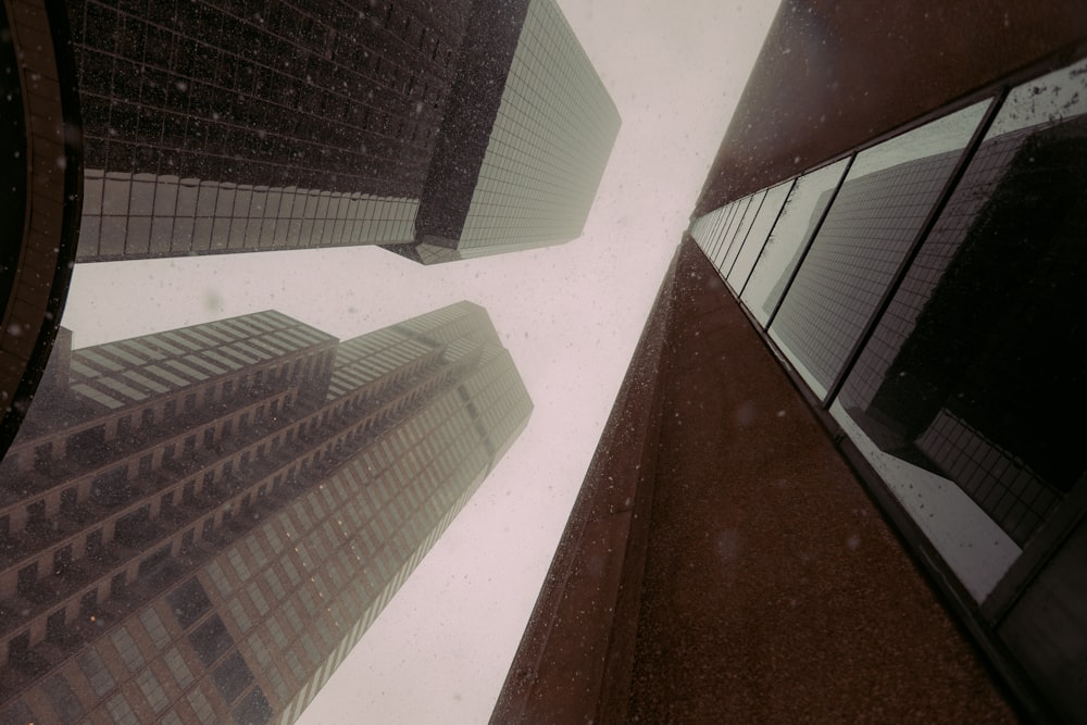 looking up at tall buildings in a city