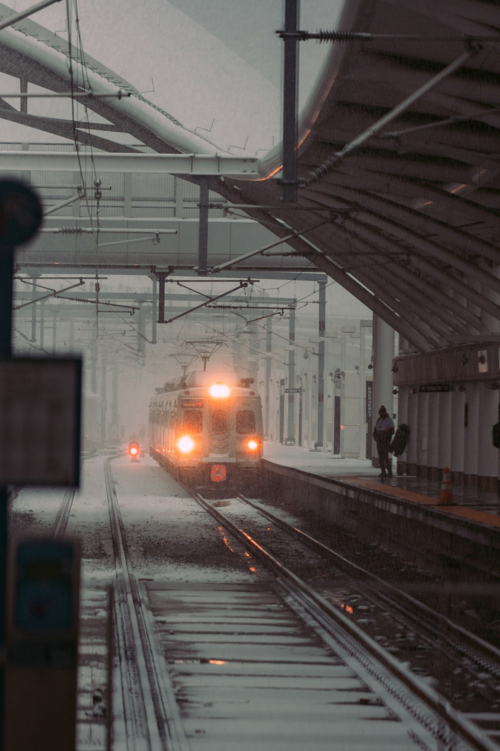 a train traveling down train tracks next to a train station