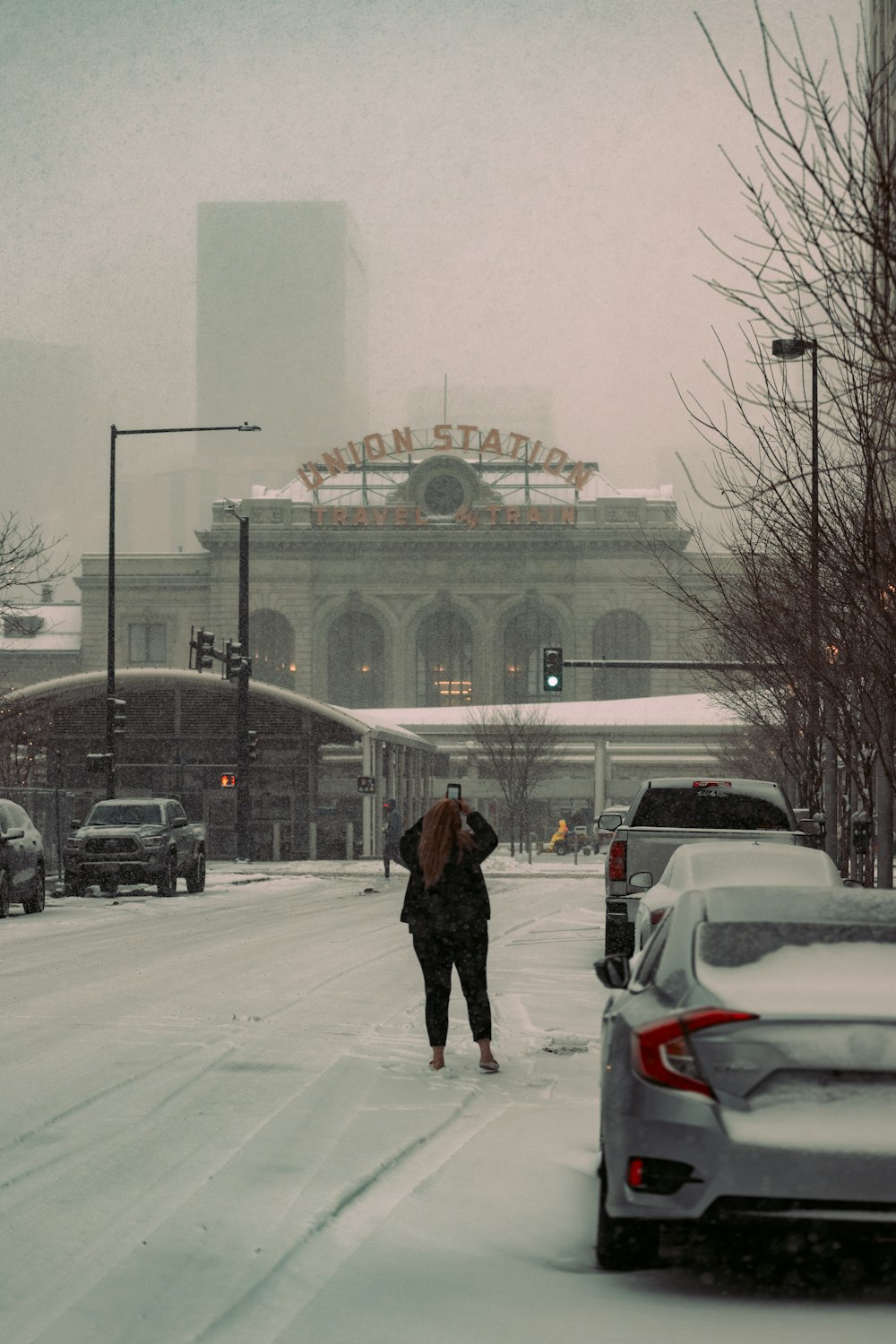 a person walking across a snow covered street