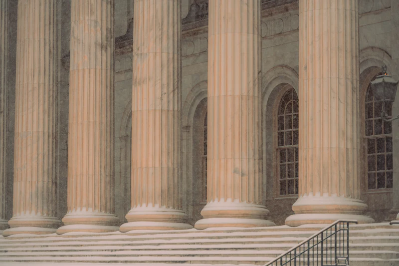 The stone steps and columns of a Canadian courthouse in soft daylight