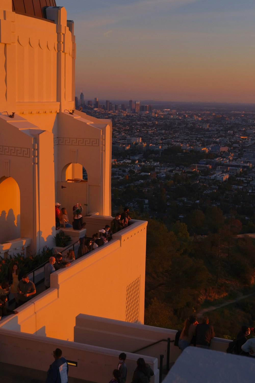 a group of people sitting on top of a building