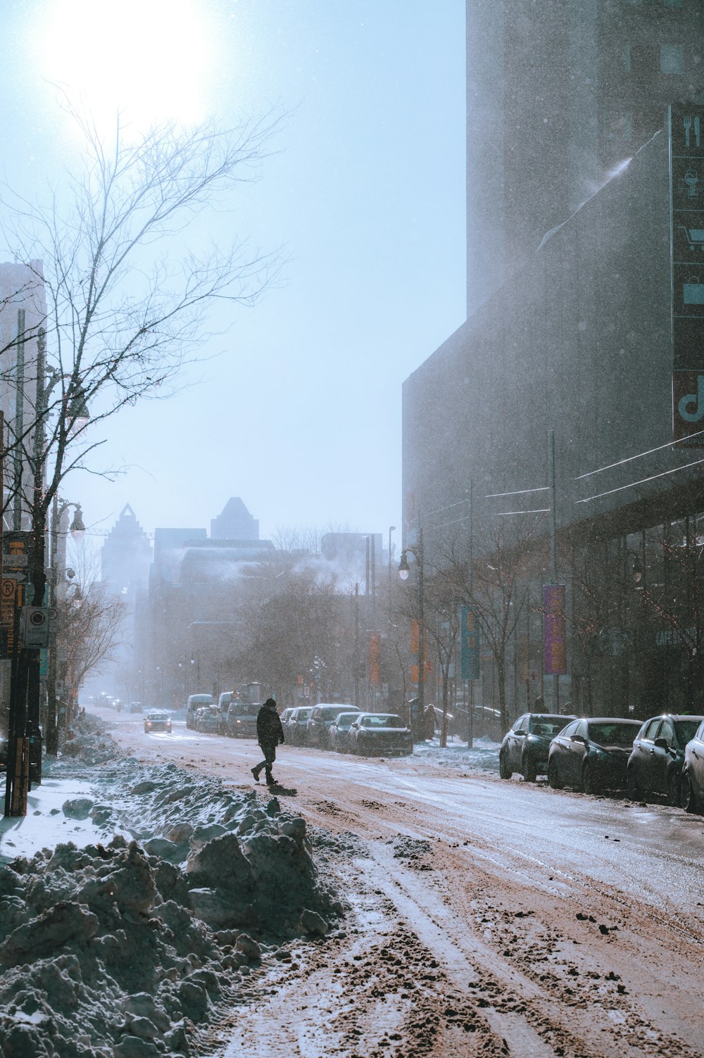 a person walking down a snow covered street