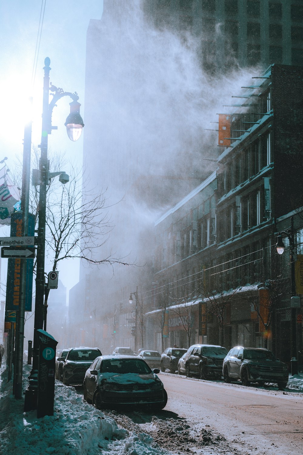 a street filled with lots of snow next to tall buildings