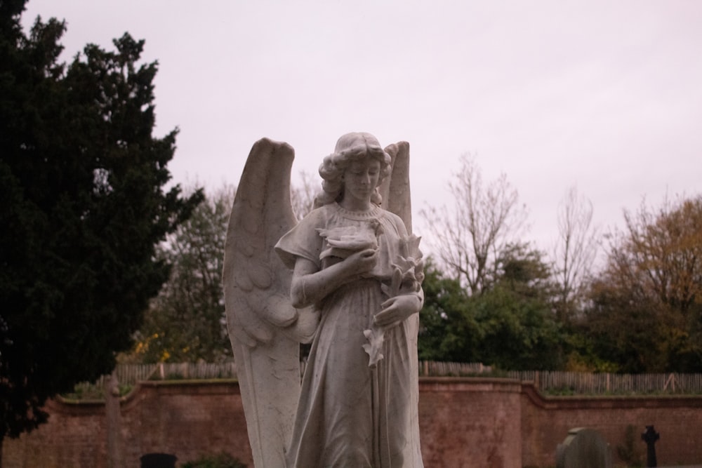 a statue of an angel holding a baby