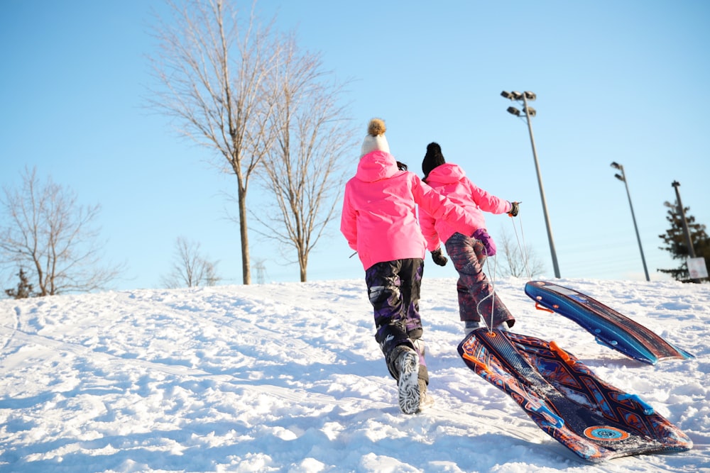 a couple of people that are standing in the snow