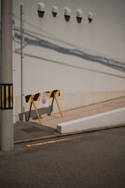 a yellow and black sign sitting on the side of a road