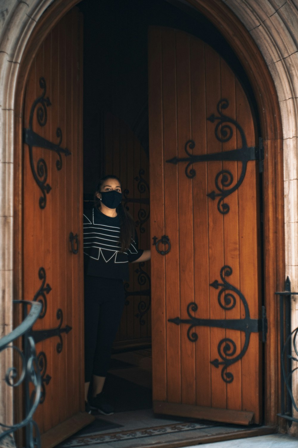 a woman standing in front of a wooden door