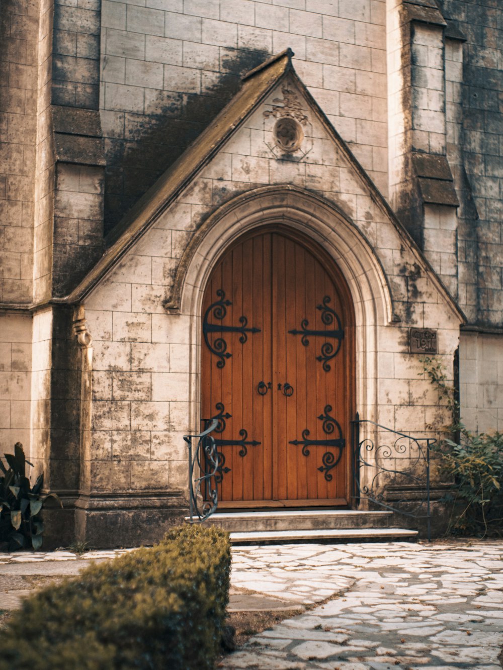 an old church with a wooden door and brick walls