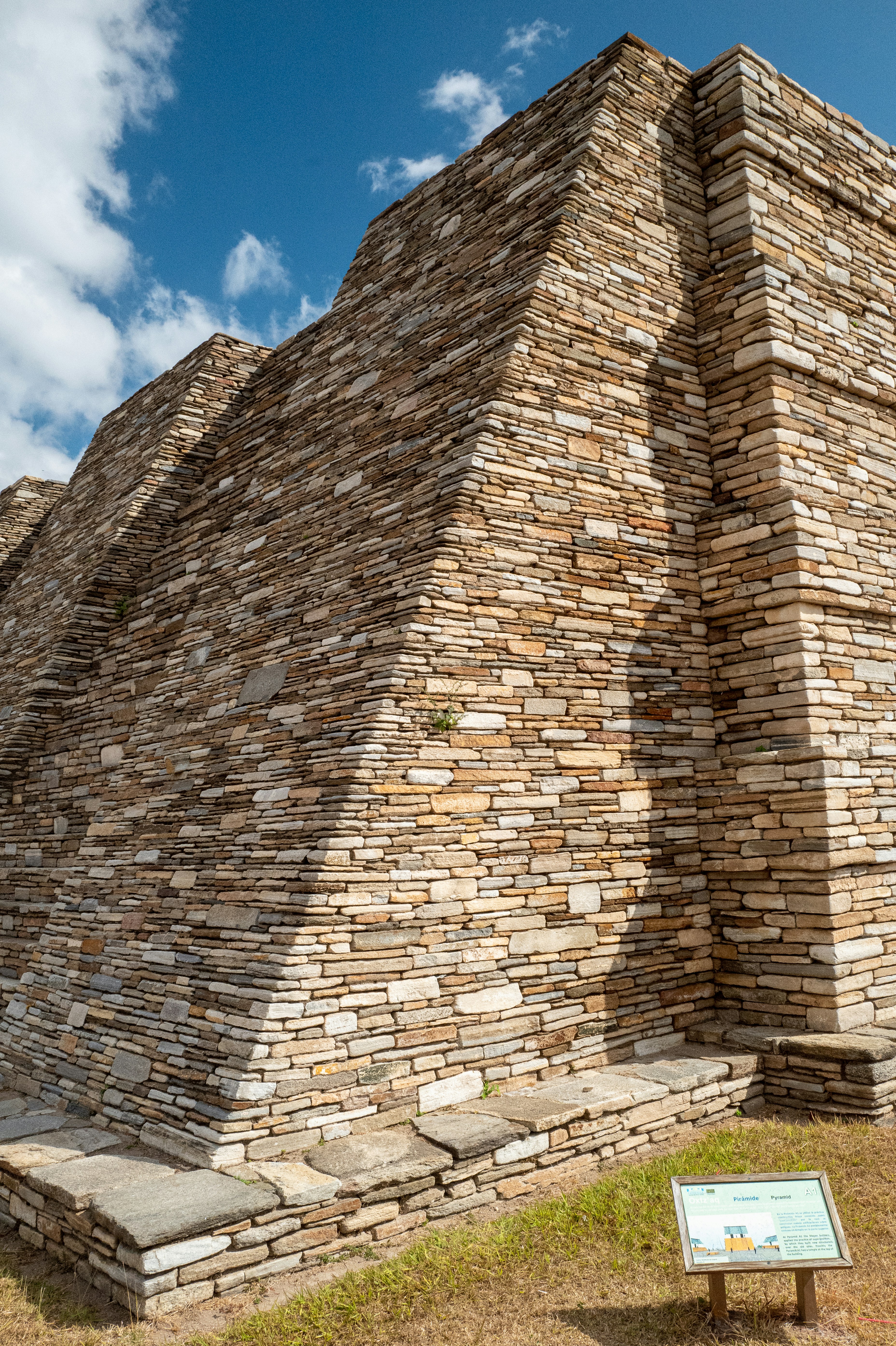 a stone structure with a sign in front of it