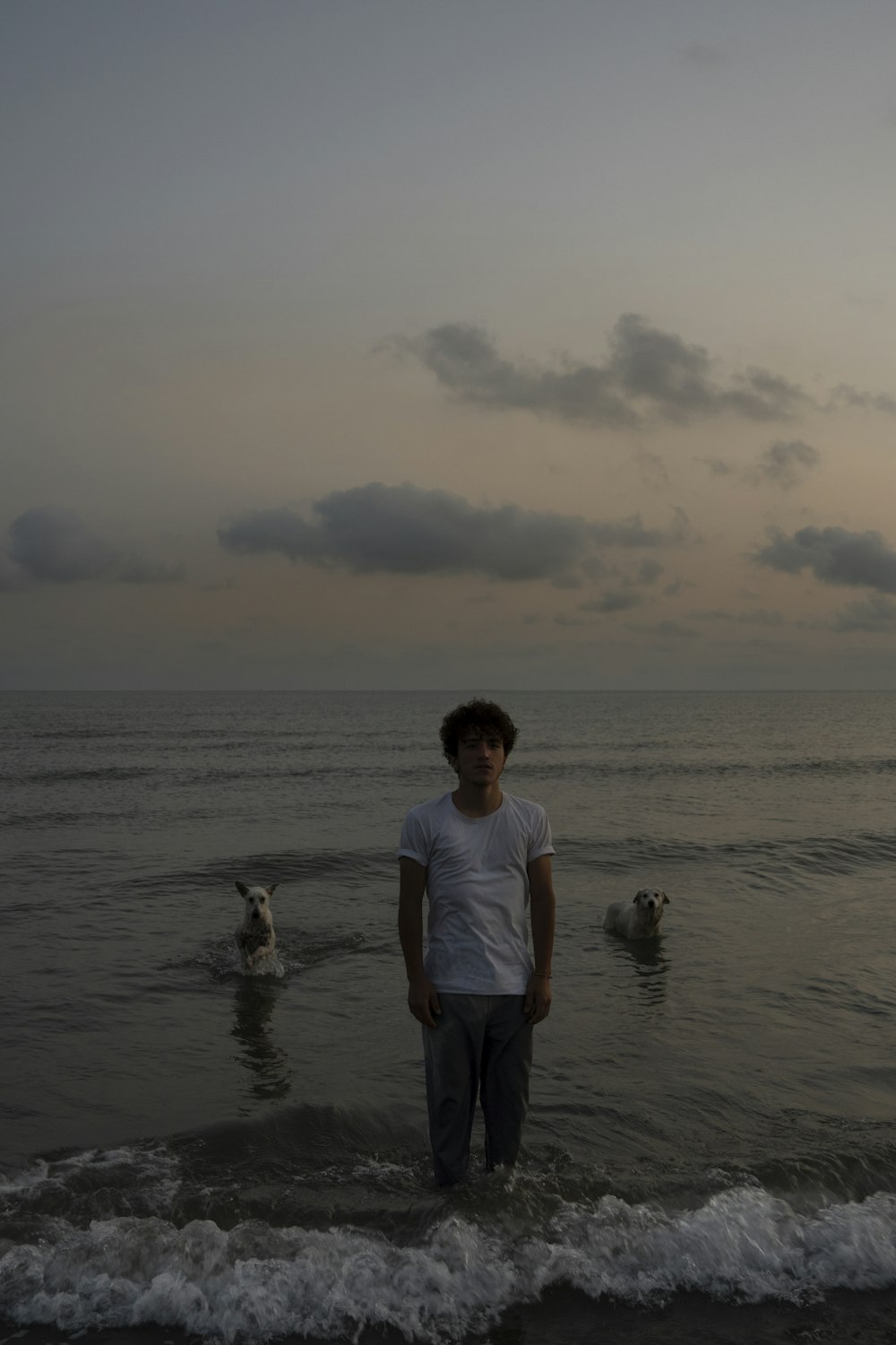 a man standing in the water at the beach