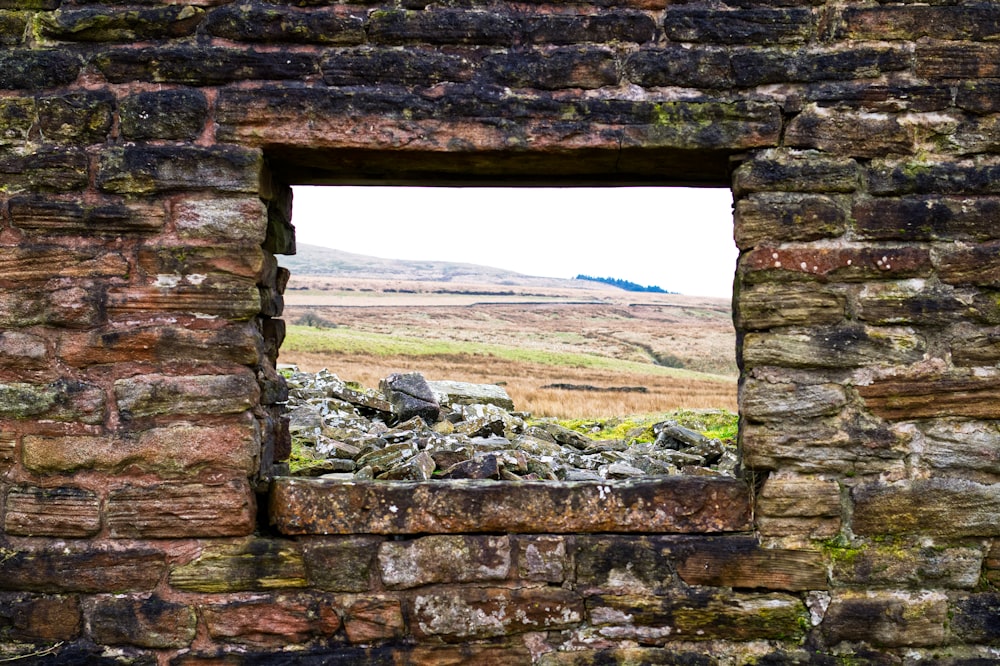 a stone wall with a window in it