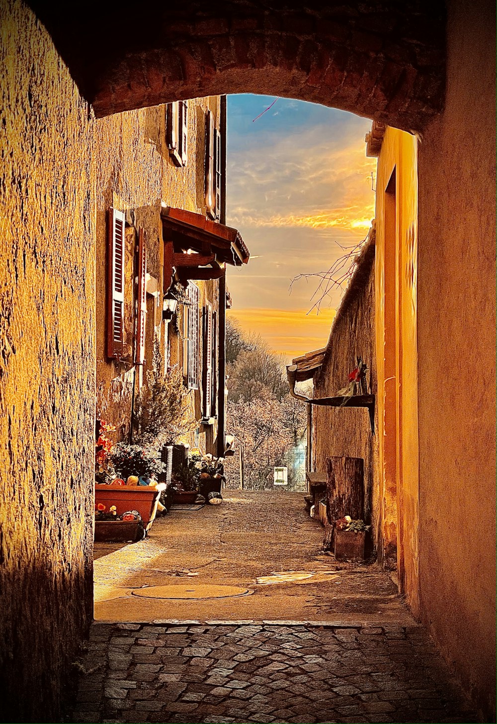 an alley way with a stone walkway between two buildings