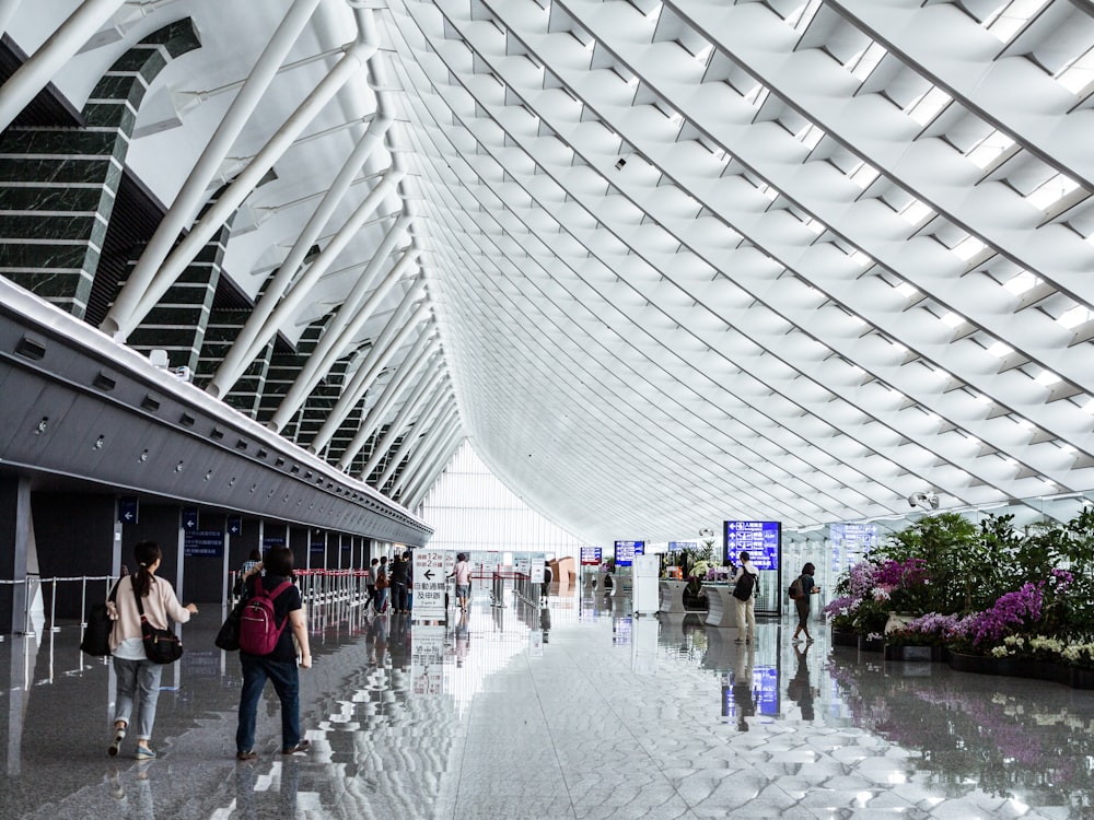 a group of people walking through an airport