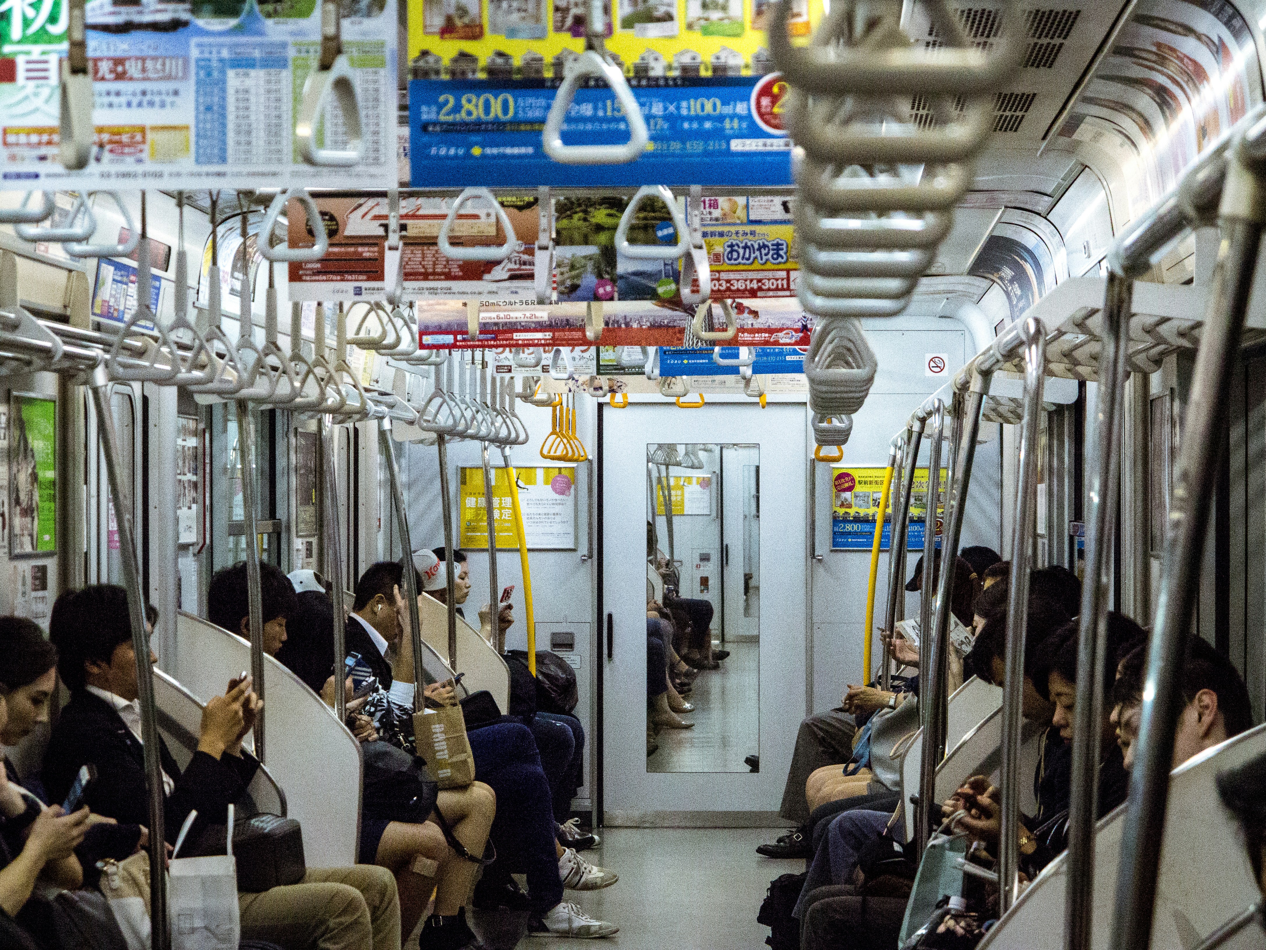 Packed commuter train in Tokyo, showing many passengers inside
