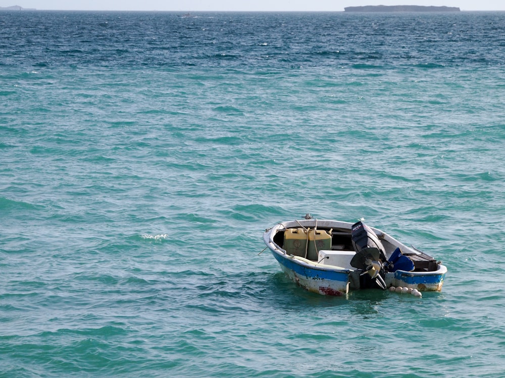 a small boat floating on top of a large body of water