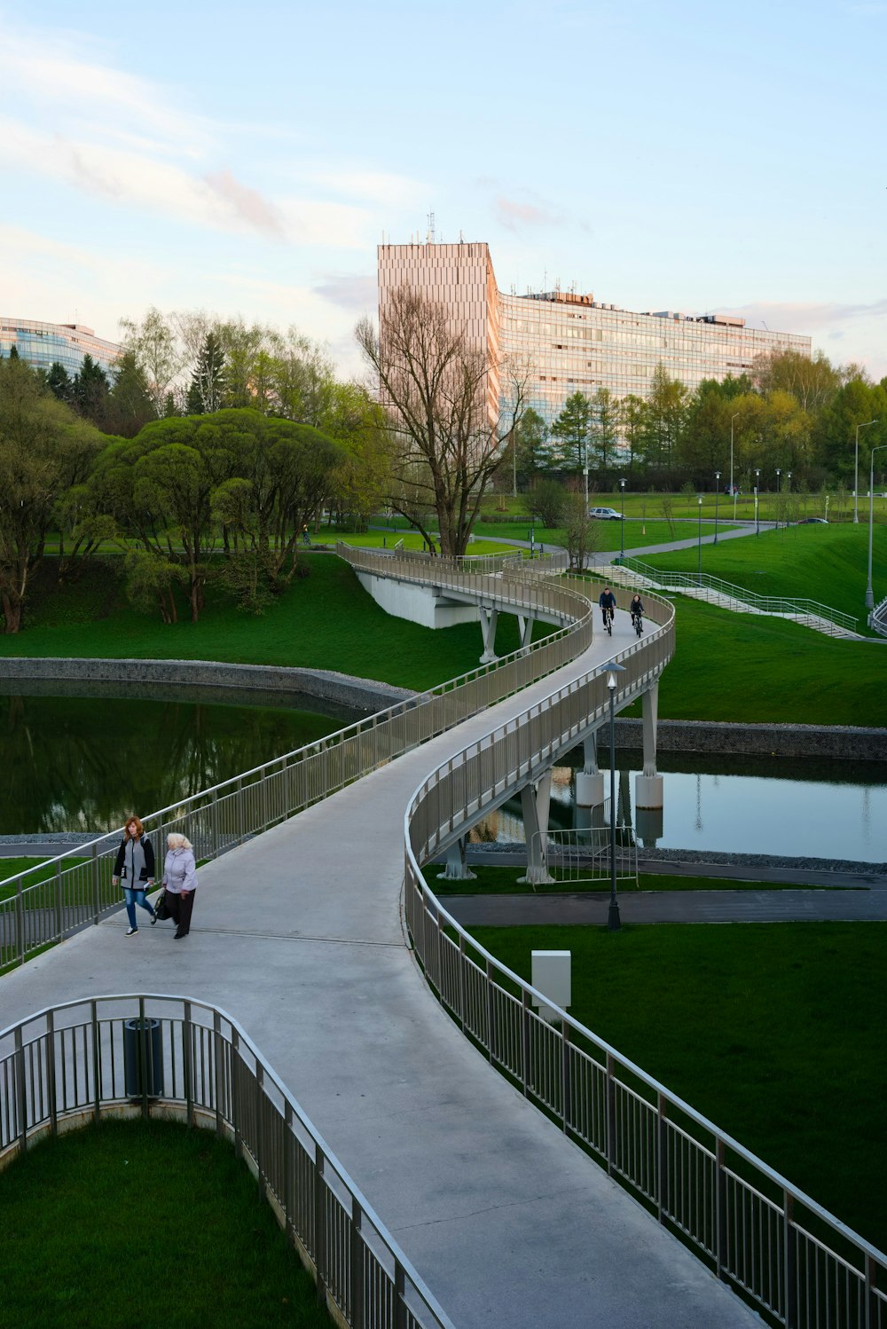 two people walking down a path in a park