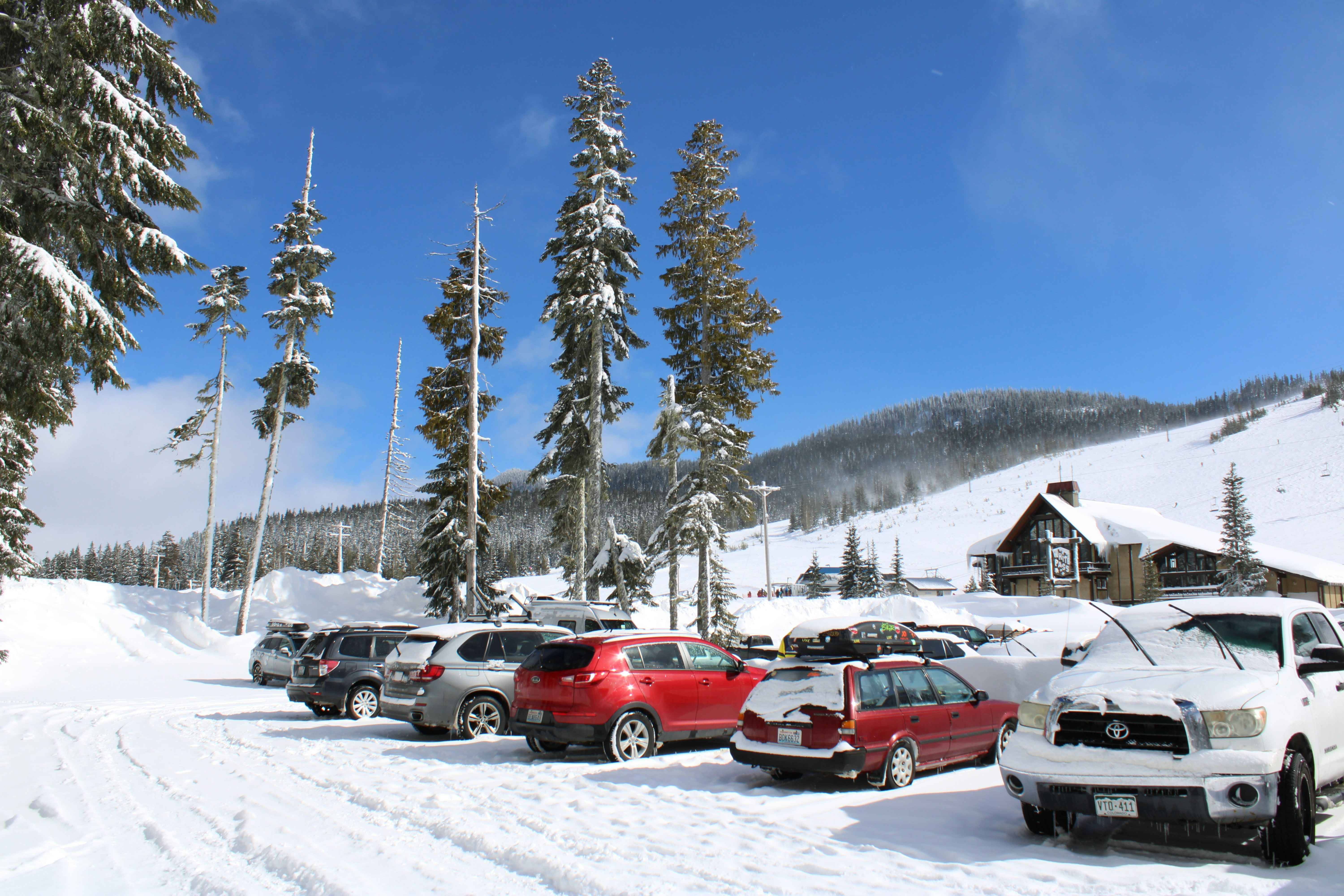 a bunch of cars that are parked in the snow