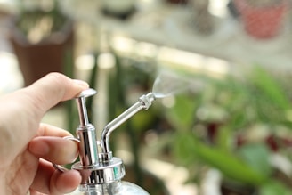 a person is holding a water faucet in their hand