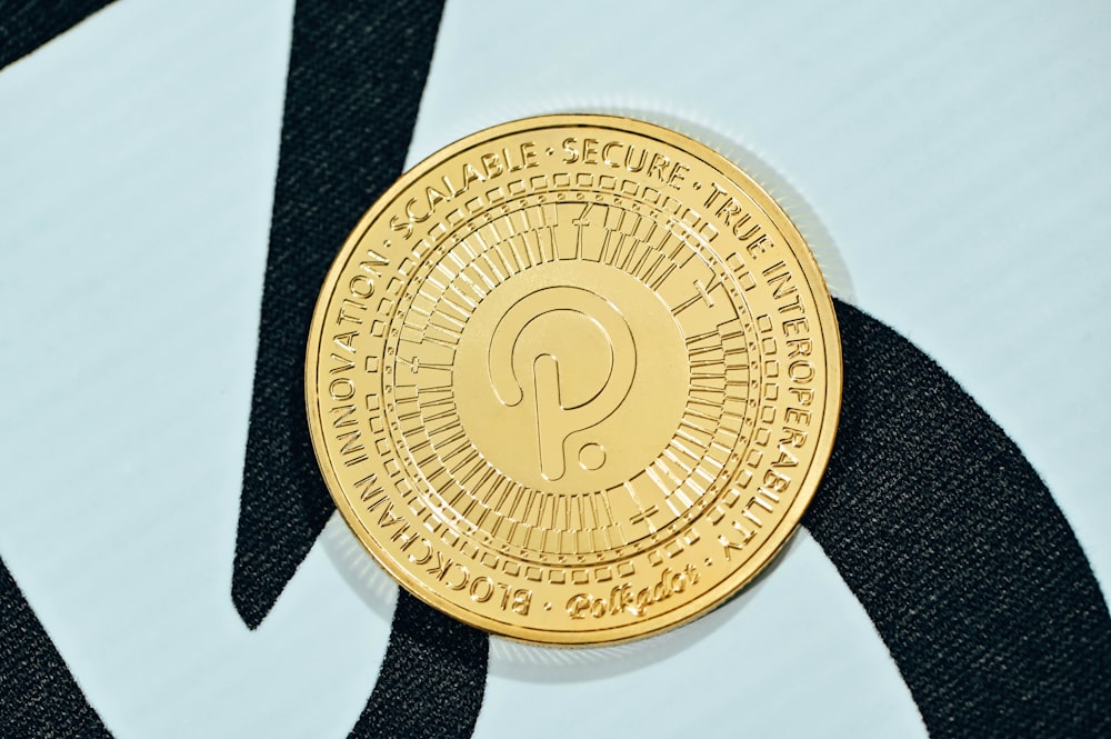 a close up of a gold coin on a black and white background