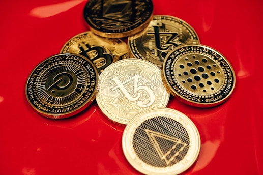 a pile of coins sitting on top of a red table