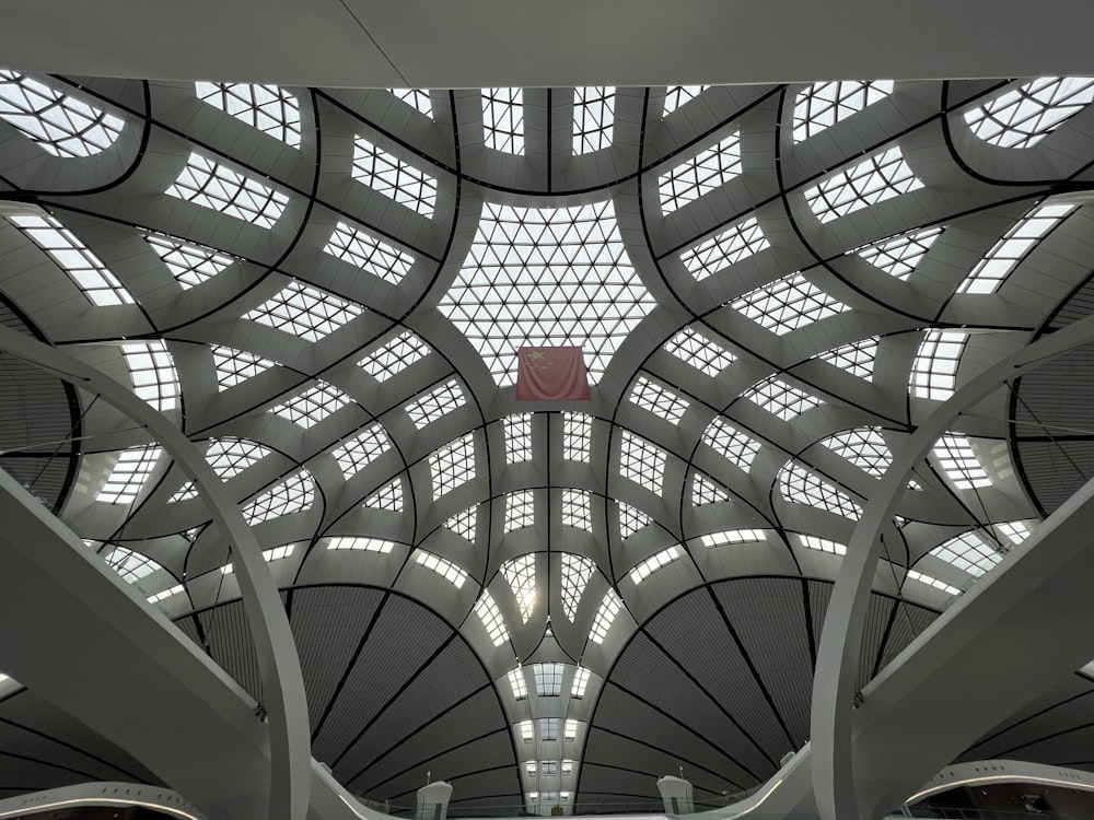 the ceiling of a train station with many windows