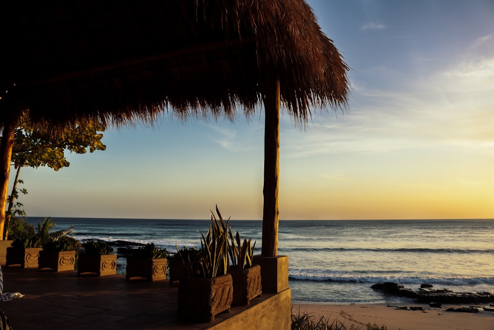 the sun is setting over the ocean and the beach