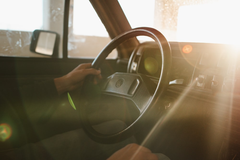 a person driving a car on a sunny day