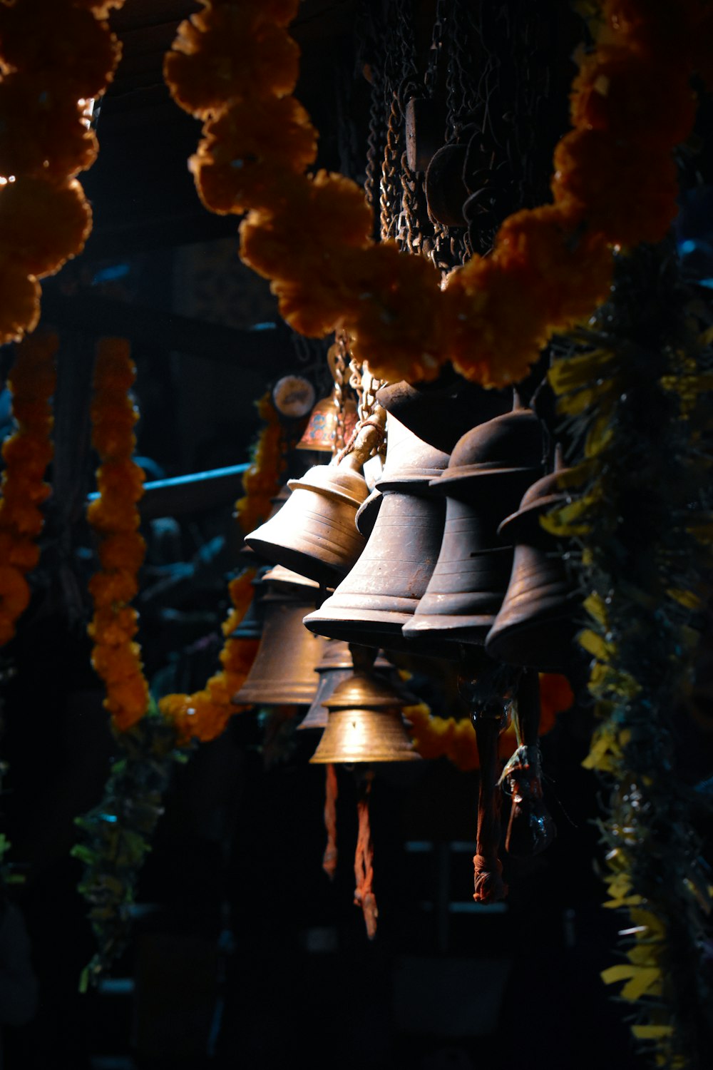 a group of bells hanging from a ceiling