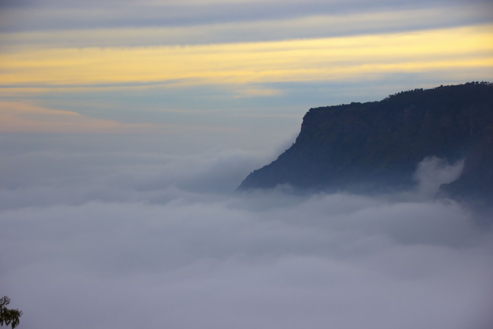 a view of a mountain covered in fog