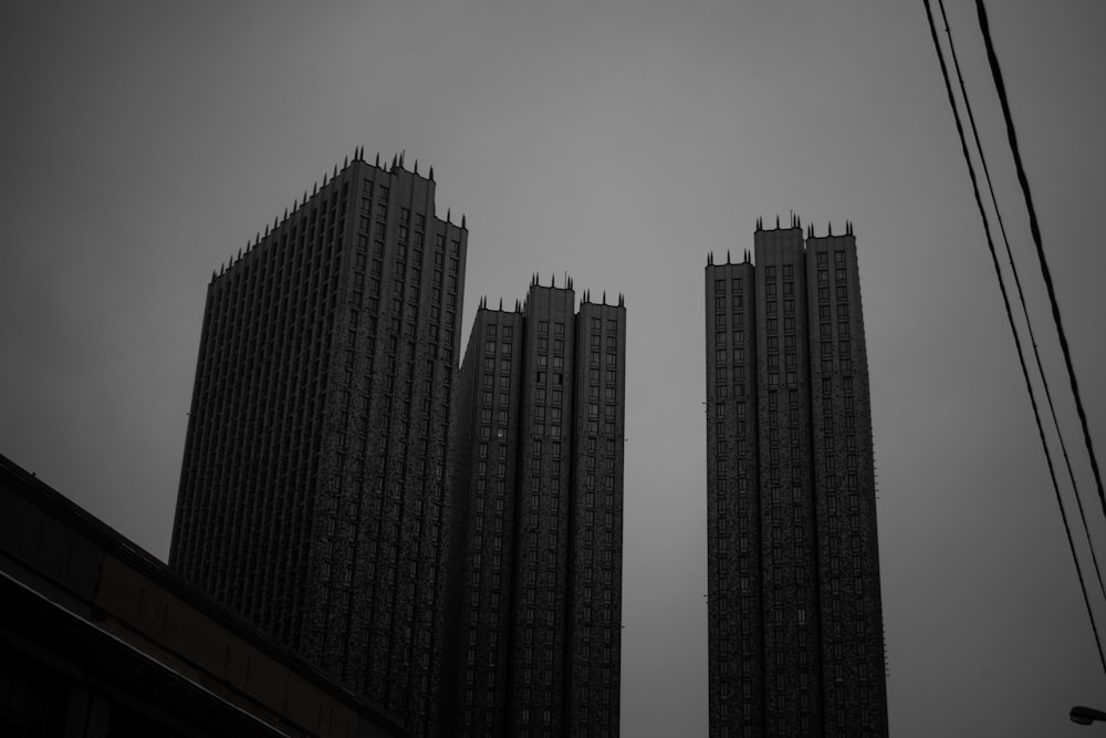 a black and white photo of two tall buildings