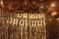 a happy birthday banner with balloons and streamers