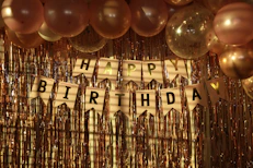 a happy birthday banner with balloons and streamers