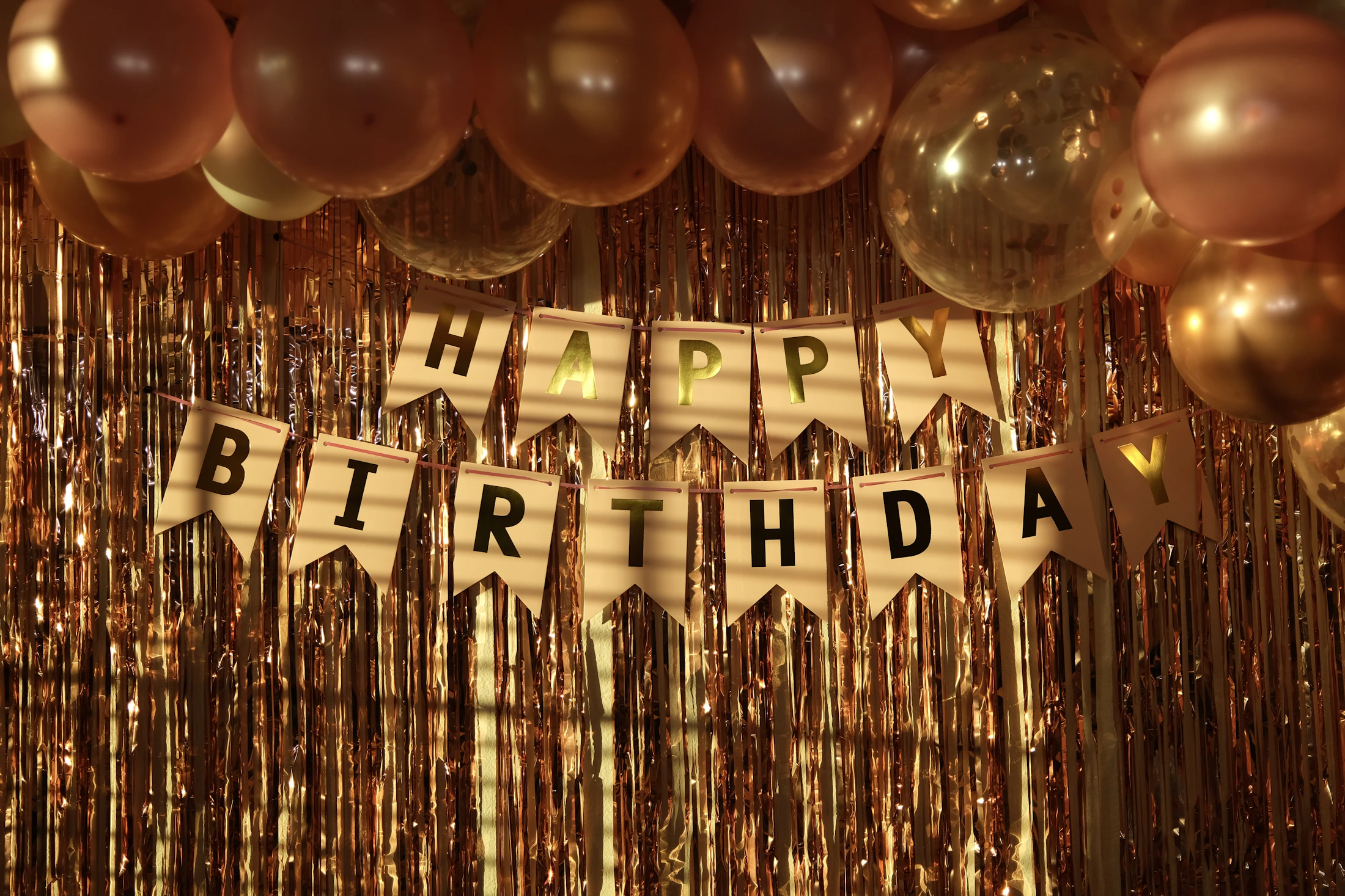 Birthday celebration decorated with balloons, streamers, and a festive banner