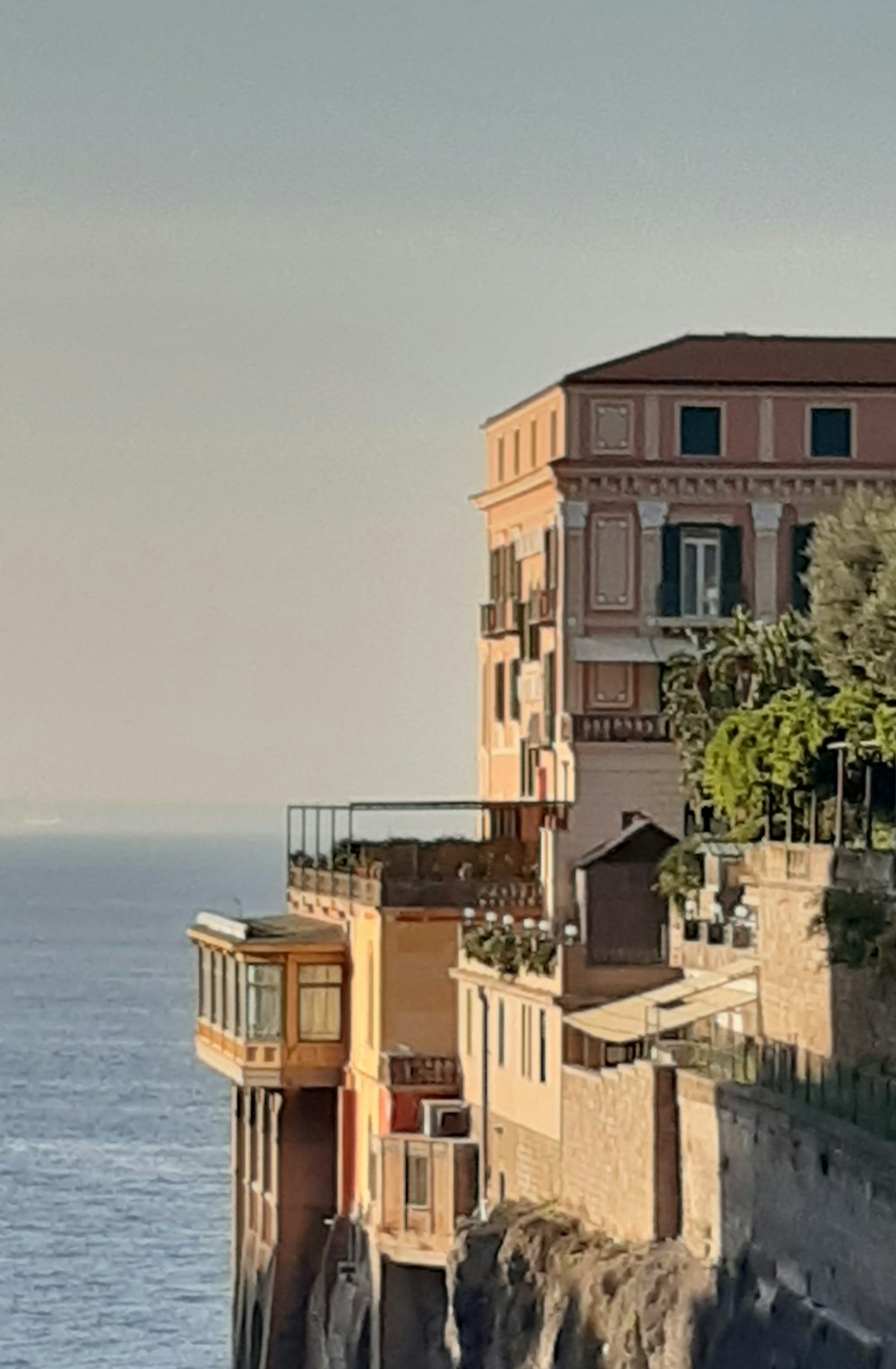 a building on a cliff overlooking the ocean