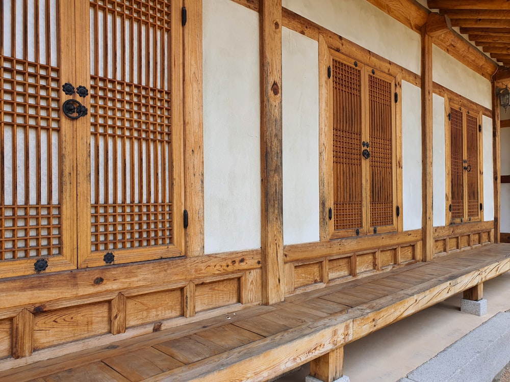 a wooden bench sitting in front of a building