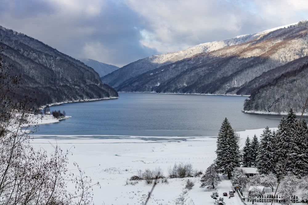 a large body of water surrounded by snow covered mountains