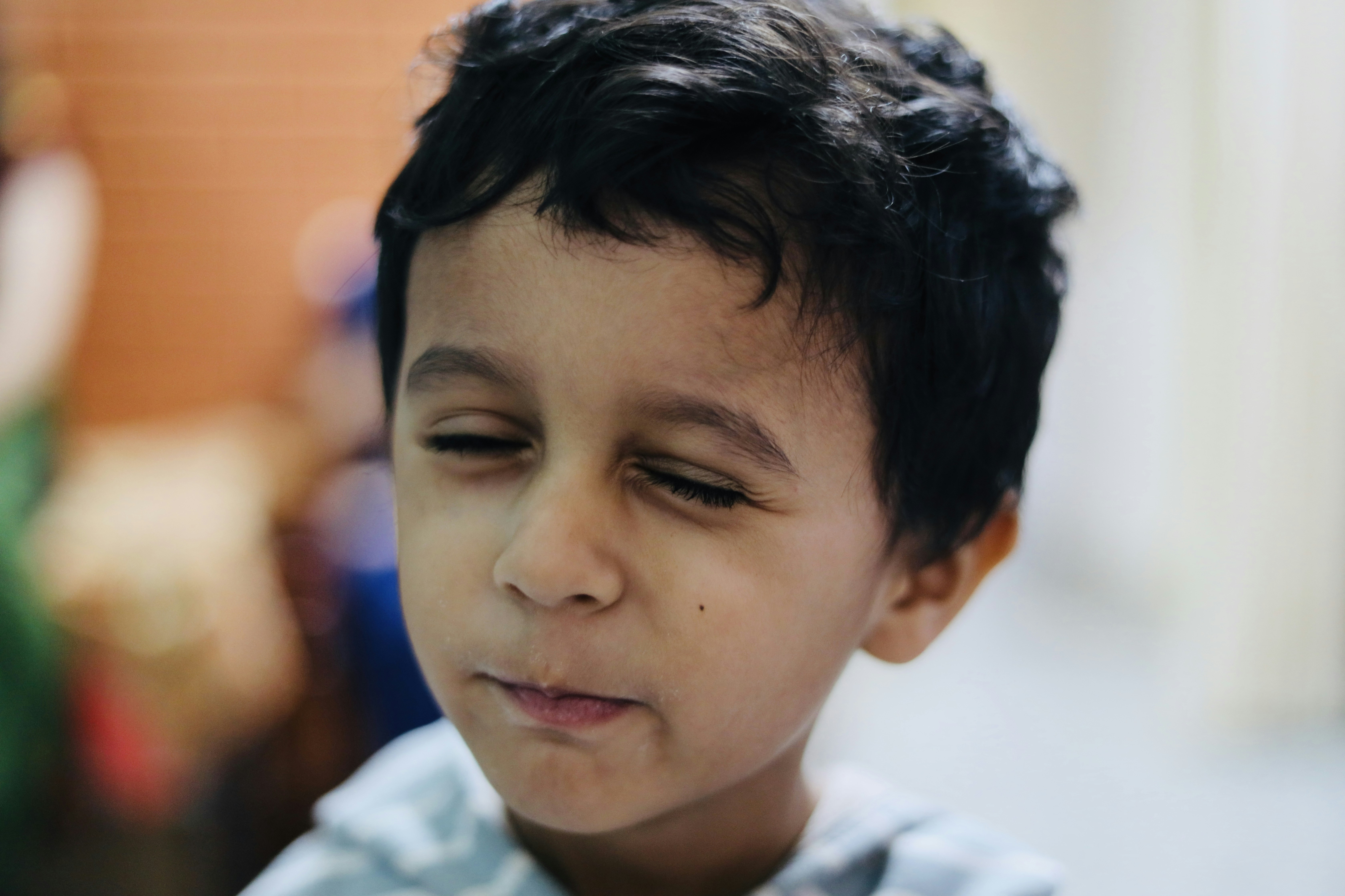 a close up of a child with a cell phone