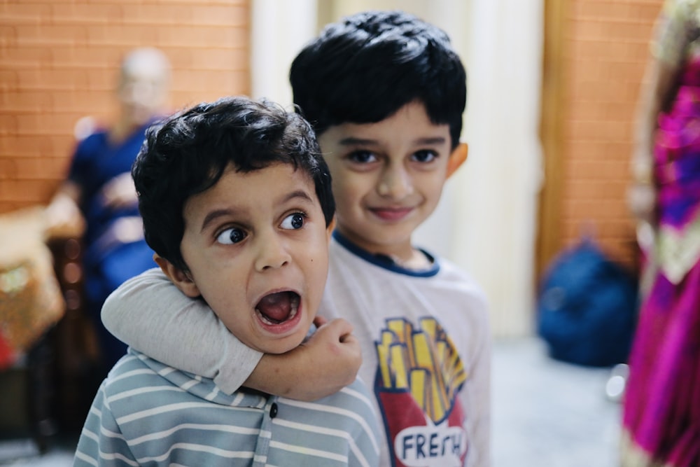 two young boys standing next to each other