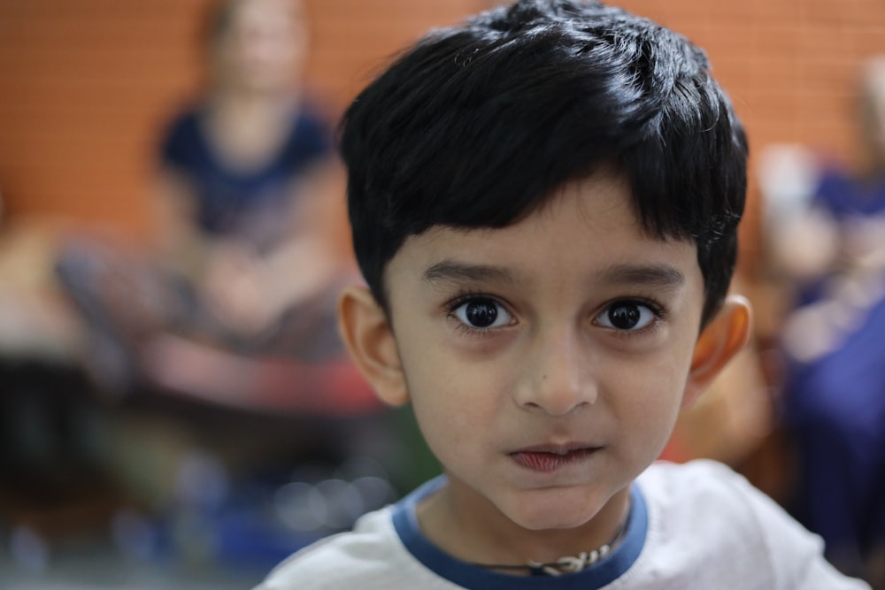 a young boy with a serious look on his face