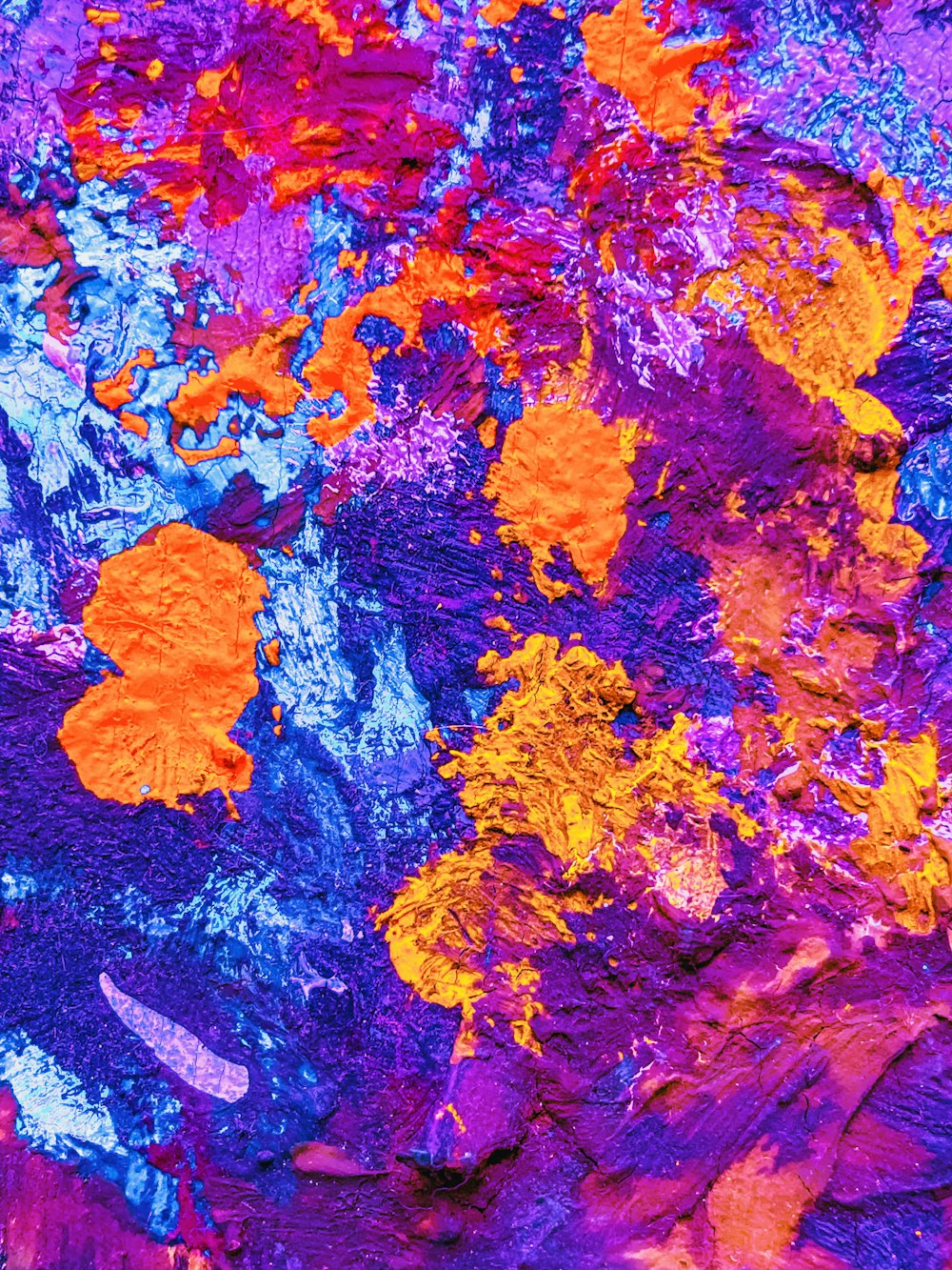 a close up of a purple and orange paint