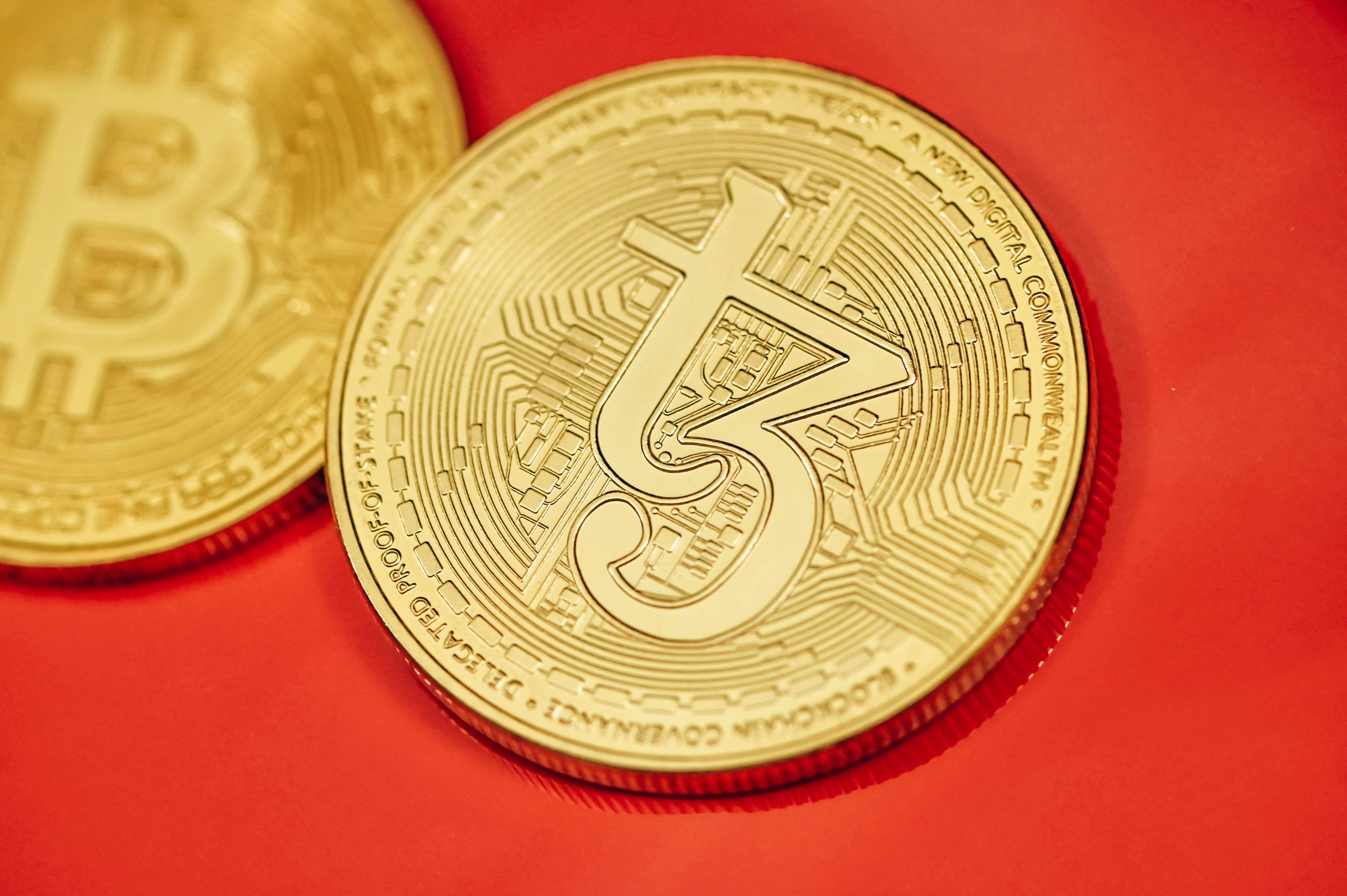 A close up of two gold bitcoins on a red surface photo – Free Business  Image on Unsplash