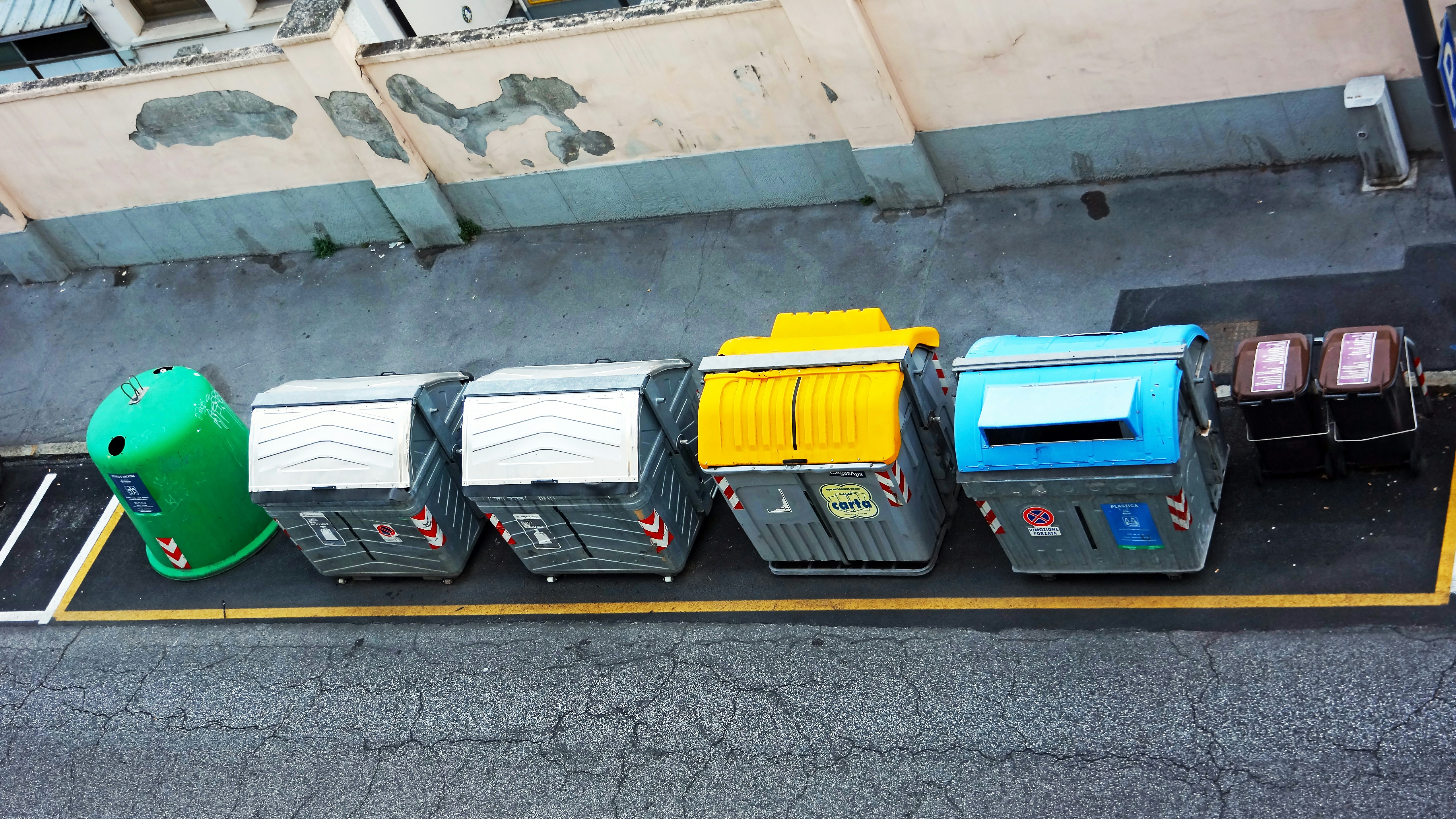 Electric delivery van being loaded with cargo at a city curb