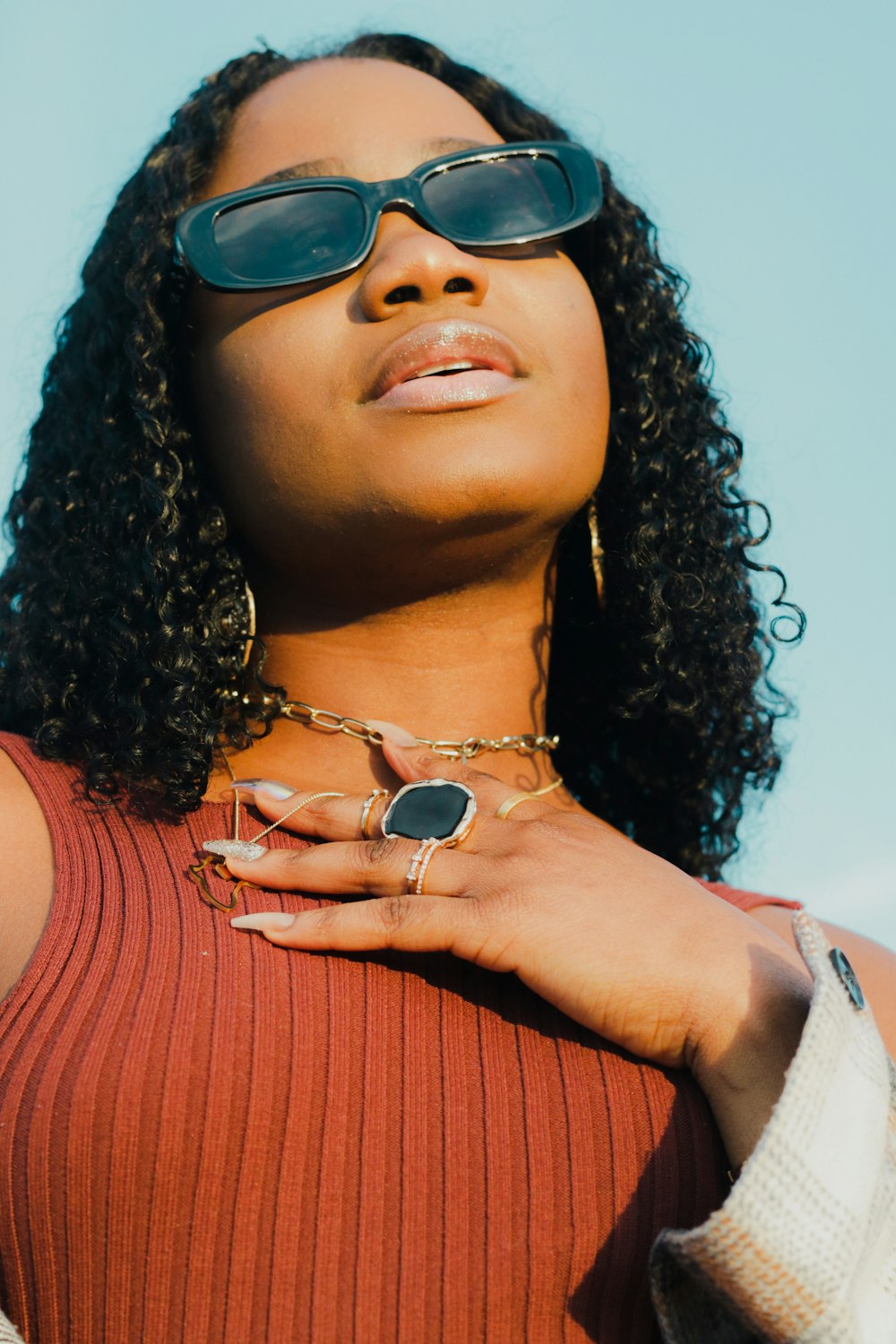 a woman wearing sunglasses and a necklace