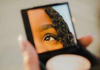 a woman holding a compact compact compact compact compact compact compact compact compact compact compact compact