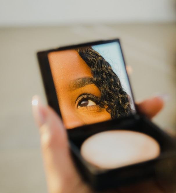 a woman holding a compact compact compact compact compact compact compact compact compact compact compact compact