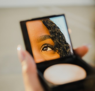 a woman holding a compact compact compact compact compact compact compact compact compact compact compact compact