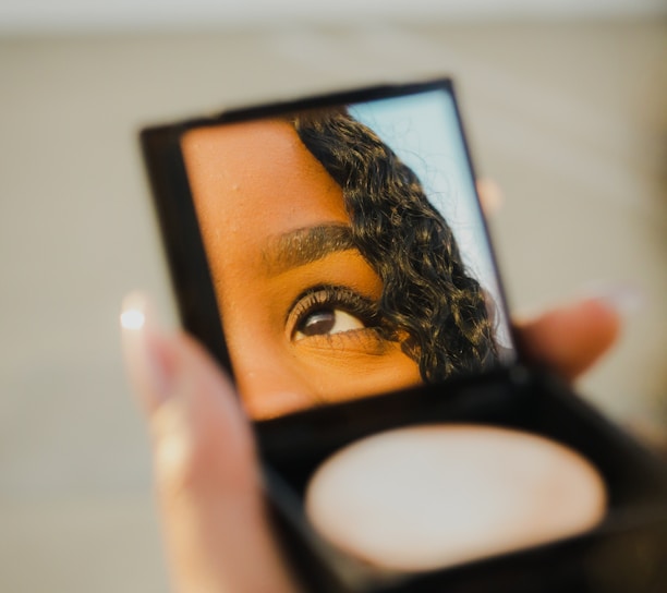 a woman holding a compact compact compact compact compact compact compact compact compact compact compact compact