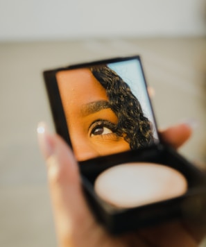 a woman holding a compact compact compact compact compact compact compact compact compact compact compact compact