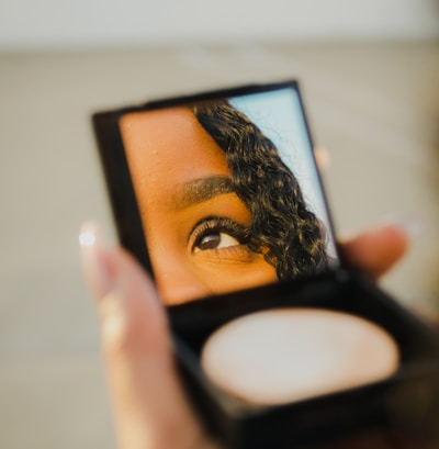 a woman holding a compact compact compact compact compact compact compact compact compact compact compact compact